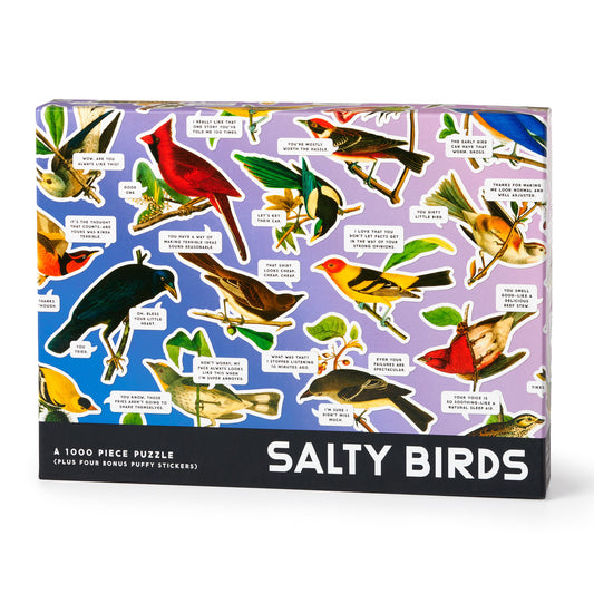 The Brass Monkey Salty Birds 1000 Piece Puzzle features a lively bird collage with sassy speech bubbles on a purple background and comes with four bonus puffy stickers noted on the box.