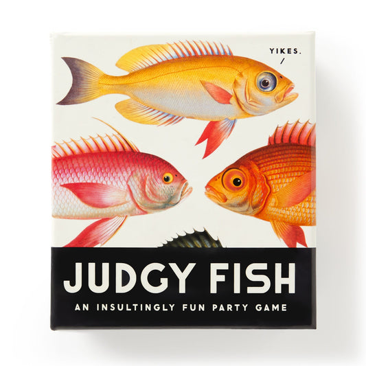 The Judgy Fish Game by Brass Monkey comes in a box with colorful fish illustrations, the word “Yikes.” above one fish, and the title “Judgy Fish: An insultingly fun insults game” in bold white on black.
