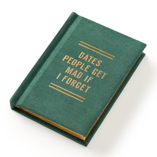 A hard-bound green Dates People Get Mad If I Forget Tiny Diary by Brass Monkey, with gilded page edges and gold cover text, lies slightly tilted on a white surface.