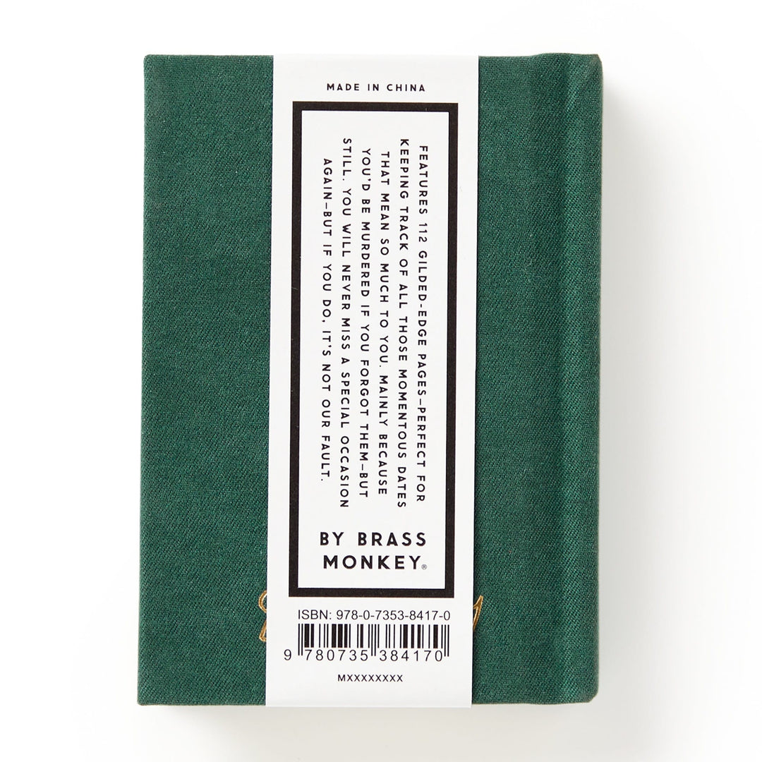 A small, hard-bound green Dates People Get Mad If I Forget Tiny Diary by Brass Monkey with a white back label describing its use for organizing murder mysteries and an ISBN barcode at the bottom.