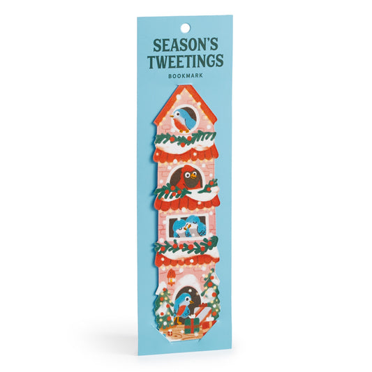 A festive Seasons Tweetings Paper Bookmark by Éléna Comte features a tall red birdhouse with garlands, birds, and gifts, attached to blue packaging—a perfect holiday reading accessory.