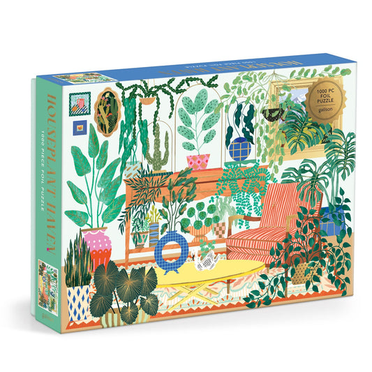 The Houseplant Haven 1000 Piece Foil Puzzle by Faye Guanipa features a vibrant illustrated living room with potted plants, a striped orange sofa, and decorative accents on the colorful box.