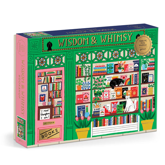 The Holly Maguire Wisdom & Whimsy Bookshop 1000 Piece Foil Puzzle showcases an illustrated bookstore facade with books, plants, a black cat, and a white dog in the window amid lush greenery and decorative details.