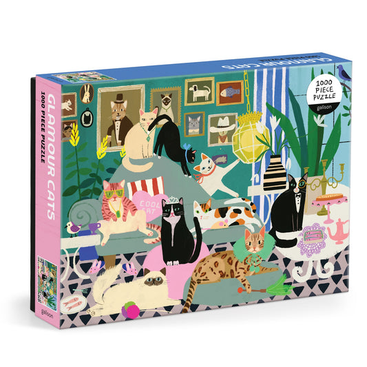The Anne Bentley Glamour Cats 1000 Piece Puzzle features a vibrant illustrated scene of stylish cats lounging in a chic living room with plants, portraits, and elegant furniture—perfect for cat lovers and puzzle fans alike.