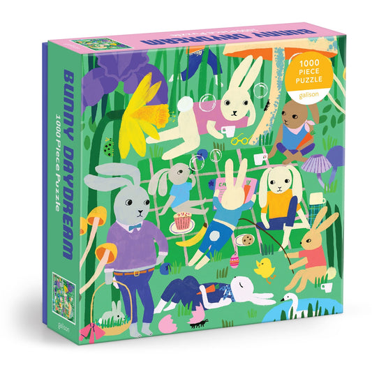 The Anne Bentley Bunny Daydream 1000 Piece Puzzle features illustrated bunnies playing and relaxing in a whimsical garden filled with flowers, balloons, and bubbles.