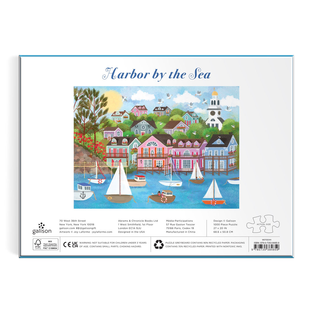 The Joy Laforme Harbor by the Sea 1000 Piece Puzzle showcases a vibrant Nantucket harbor scene with sailboats, colorful houses, trees, and a white church—an ideal addition to any puzzle lover’s collection.