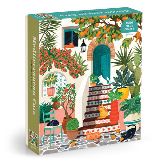 The Mediterranean Cats 1000 Piece Puzzle by Tània Garcia features a vibrant courtyard scene with colorful plants, pottery, and cats lounging on steps near a blue door.