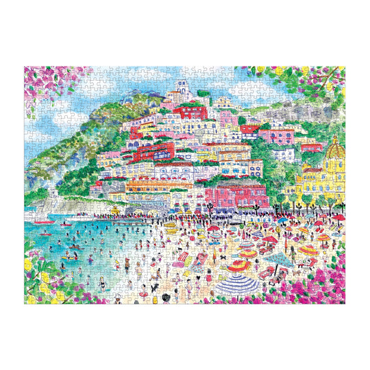 Vibrant illustration of Positano, Italy on the Michael Storrings Coast of Italy 1000 Piece Puzzle; colorful houses dot a green hillside under a blue sky, framed by pink flowers—a perfect art lover gift from Michael Storrings.