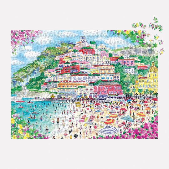 The Michael Storrings Coast of Italy 1000 Piece Puzzle by Michael Storrings features a vibrant beach scene with a hillside town. Some pieces are missing in the top right—an ideal gift for art lovers.