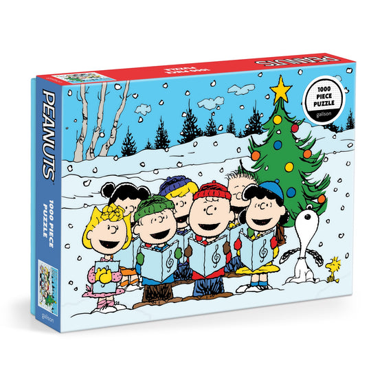 The Peanuts Christmas Caroling 1000 Piece Puzzle by Peanuts Worldwide, LLC features beloved characters caroling by a decorated tree in a snowy, festive setting.