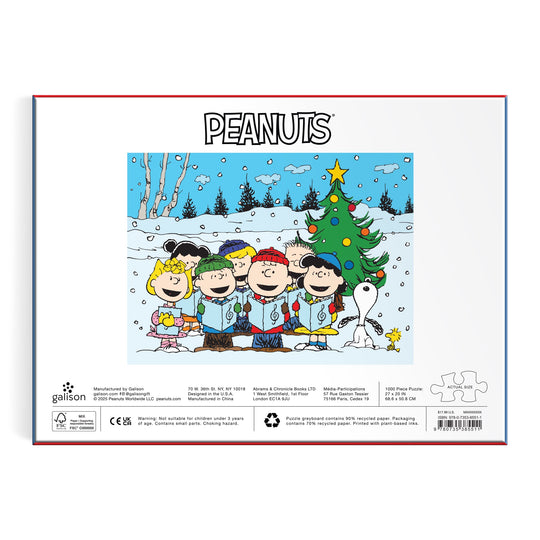The Peanuts Christmas Caroling 1000 Piece Puzzle by Peanuts Worldwide, LLC features the characters singing in the snow by a decorated tree with Snoopy, under the word PEANUTS—a charming holiday scene perfect for fans.