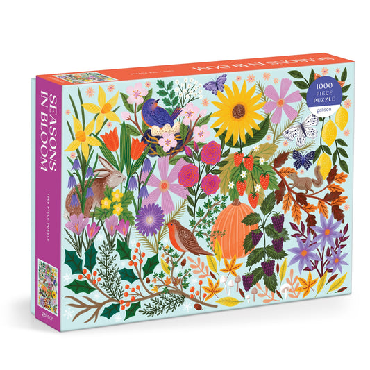 The Lee Foster-Wilson Seasons in Bloom 1000 Piece Puzzle features vibrant flowers, birds, leaves, berries, and butterflies on a crisp white background for a lively nature-themed challenge.