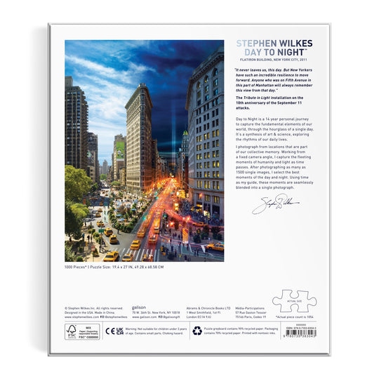 The Stephen Wilkes Day To Night Flatiron 1000 Piece Puzzle features the iconic NYC Flatiron Building, blending day and night in a vibrant city scene, with descriptive text about the artwork and artist.