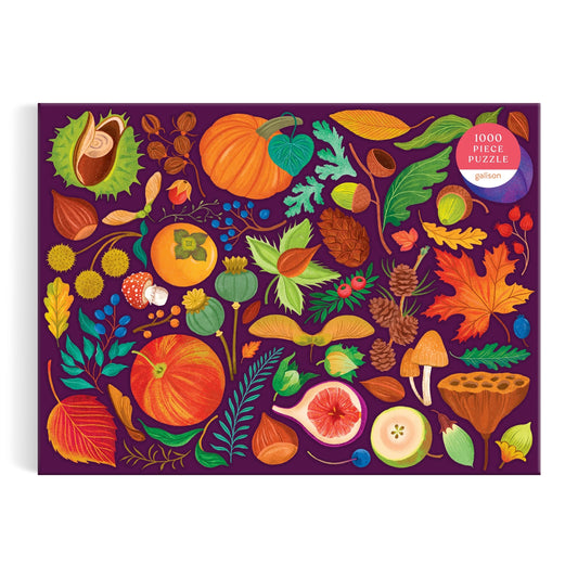 The World of Fall Flora 1000 Piece Puzzle by Dawn Cooper features a vibrant autumn design with illustrated pumpkins, mushrooms, leaves, berries, pinecones, acorns, and more on a dark purple box.