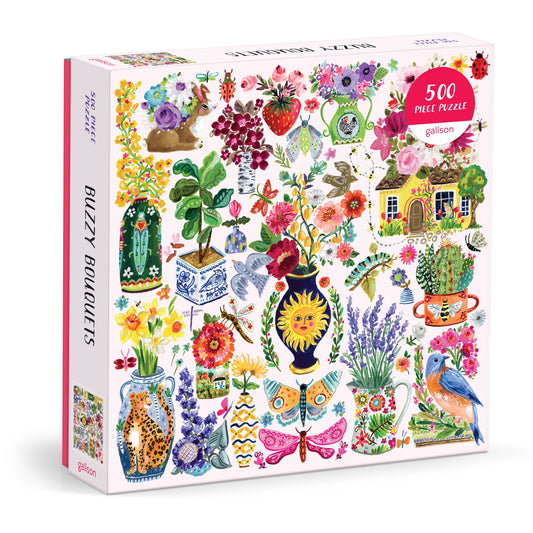 The Buzzy Bouquets 500 Piece Puzzle by Jennifer O Lewis/August Wren features vibrant painted flowers, birds, butterflies, bees, and a house surrounded by blooms—perfect for nature lovers.