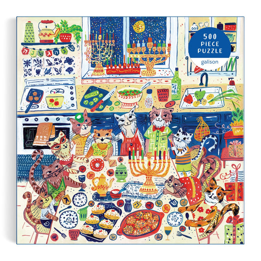 Celebrate Hanukkah with Anna Ivanir’s “Happy Hanukcats” 500 Piece Puzzle: festive cats in aprons gather in a colorful kitchen with menorahs, holiday treats, and decor as snow falls outside.