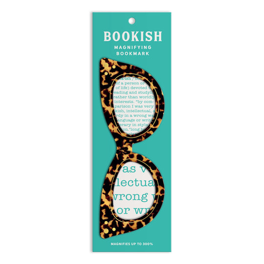 Galison’s Cat Eye Readers Bookmark with Magnifier features a tortoiseshell cat-eye design on a teal card. The retro-inspired magnifying lens makes reading easier by enlarging text beneath its playful frames.