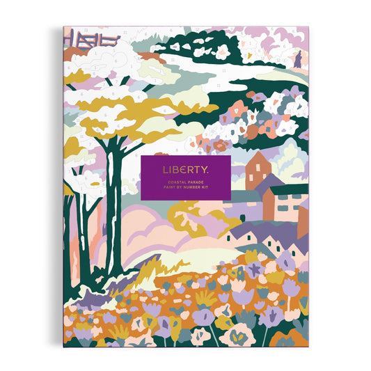 The Liberty London Coastal Parade 9 x 12" Paint by Number Kit features a vibrant landscape with trees, flowers, houses, and a barn. A central purple label displays the product name.