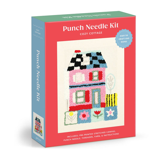 The Molly Egan Cozy Cottage Punch Needle Kit features a colorful embroidered house with trees and plants, and includes a pre-printed canvas, punch needle, threader, yarn, and instructions.