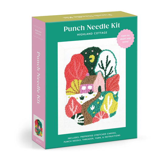 The Kika Macfarlane Highland Cottage Punch Needle Kit comes in a green box featuring a colorful cottage landscape. It includes a preprinted canvas, punch needle, threader, yarn, and instructions.