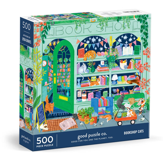 The Good Puzzle Co. Bookshop Cats 500pc Puzzle by Lee Foster-Wilson features cats in a vibrant bookshop scene with bookshelves, a stroller, doorstep, tree, and plants—an eco-friendly treat for cat lovers and bookworms.