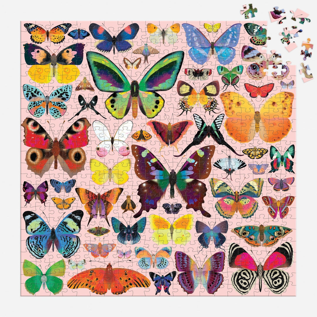 A nearly finished Brilliant Butterflies 500 Piece Puzzle by Natasha Durley shows colorful butterflies on a light pink background, with just a few pieces left to place in the top right corner.