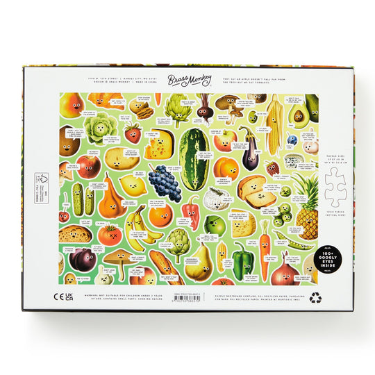 The image shows the back of the Brass Monkey Googly Food 1000 Piece Puzzle box, featuring illustrated and labeled fruits and vegetables on a white background, with a single puzzle piece and recycling icon in the corners.