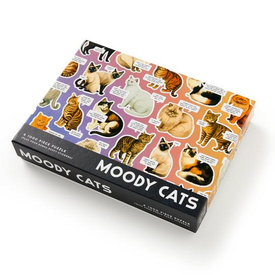 The Brass Monkey Moody Cats 1000 Piece Puzzle features illustrations of cats in different moods and fur patterns with witty captions, making it a fun jigsaw for cat lovers and puzzle fans.