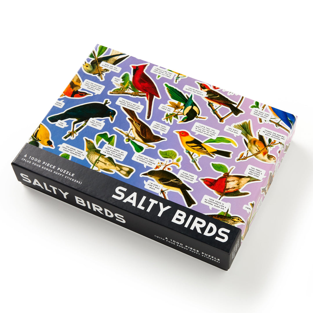The Brass Monkey Salty Birds 1000 Piece Puzzle for adults features a vibrant bird collage with witty captions on a purple background.