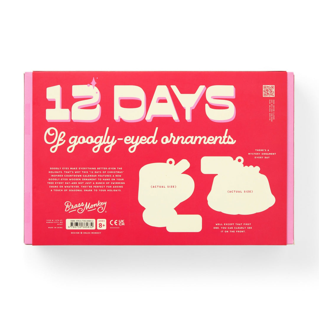 A pink and red box from Brass Monkey with white text reads Googly & Bright Holiday Ornament Countdown Calendar. The packaging features two ornament silhouettes and product info at the bottom.