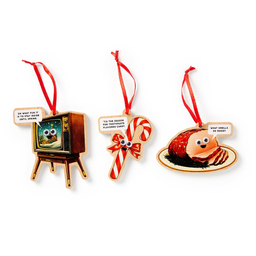 Countdown to the holidays with Brass Monkey’s Googly & Bright Holiday Ornament Calendar—featuring a retro TV, candy cane, and glazed ham ornament, each with googly eyes and cheeky sayings for festive fun!.