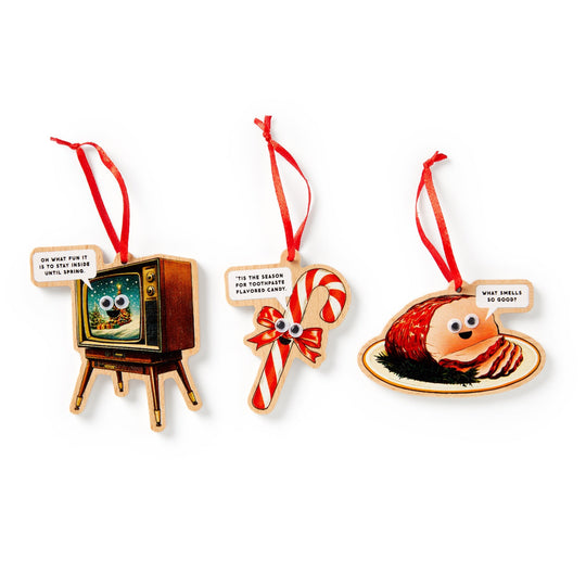 Countdown to the holidays with Brass Monkey’s Googly & Bright Holiday Ornament Calendar—featuring a retro TV, candy cane, and glazed ham ornament, each with googly eyes and cheeky sayings for festive fun!.