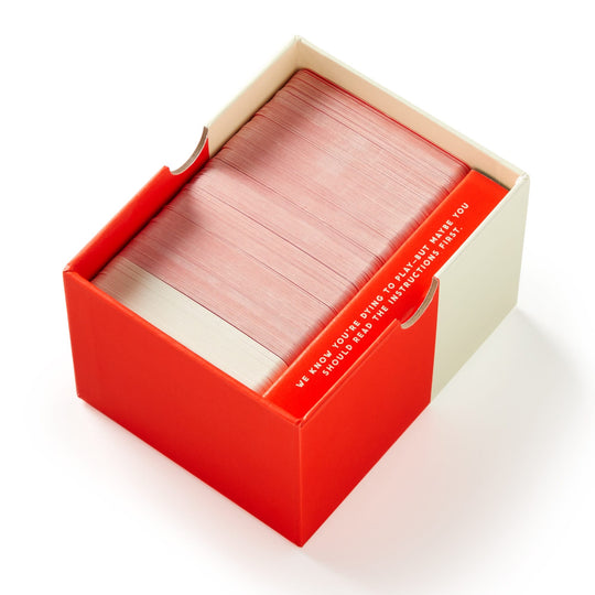 The Brass Monkey Not Today, Murder Game features a red and cream box, partly open to reveal its contents—a large stack of red-edged cards—perfect for your next party game. Text is visible on the inside flap.