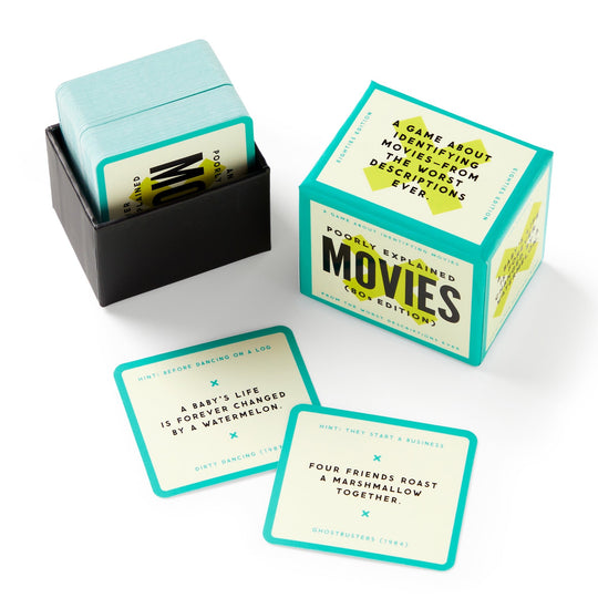 Brass Monkeys Mini Poorly Explained Movies - 80s Edition is a party game with a stack of cards, the box, and two cards displayed showing funny, vague 80s movie descriptions with answers and titles at the bottom.