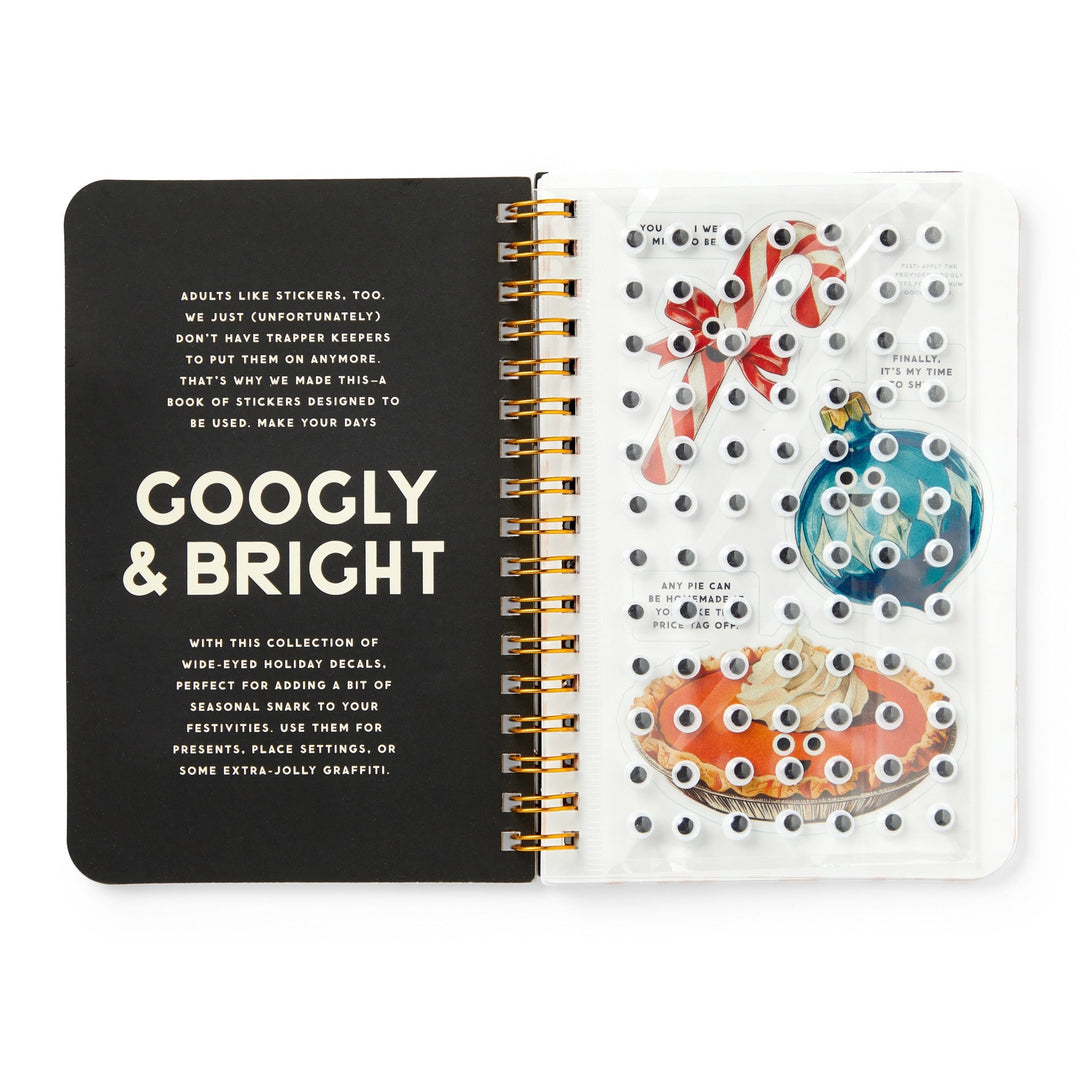 The Googly & Bright Holiday Sticker Book by Brass Monkey features spiral-bound pages with festive stickers—like candy canes, ornaments, and big holiday treats—all accented with playful googly eyes for extra cheer.