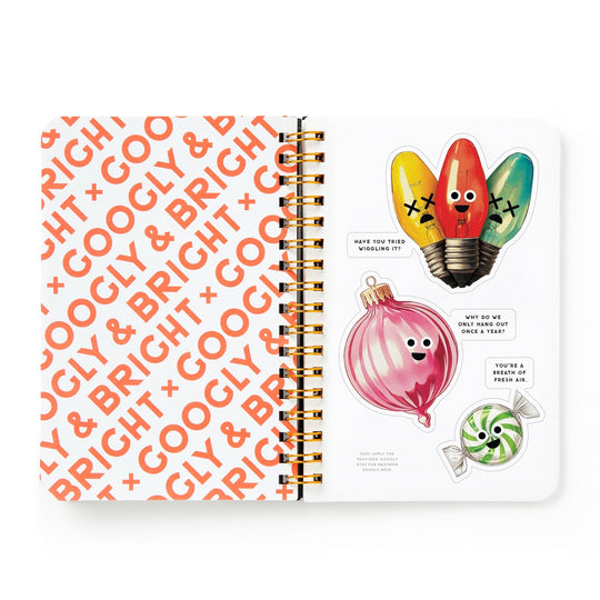 An open Brass Monkey Googly & Bright Holiday Sticker Book shows “GOOGLY & BRIGHT” in orange on the left and oversized stickers of smiling light bulbs, an onion, and a mint with funny quotes on the right.