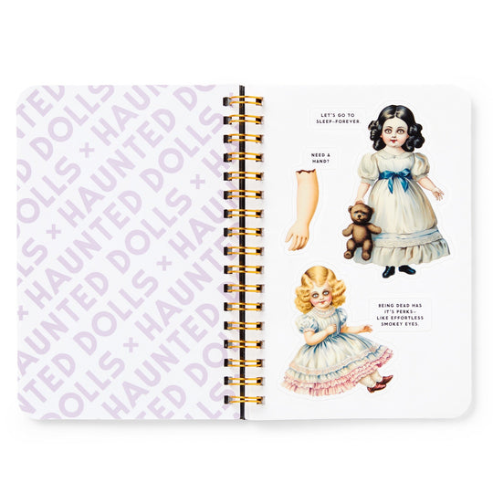 The Brass Monkey Haunted Dolls Sticker Book features a spiral-bound design with “HAUNTED DOLLS” in purple on the left page and vintage doll illustrations, oversized stickers, a teddy bear, and eerie captions on the right.