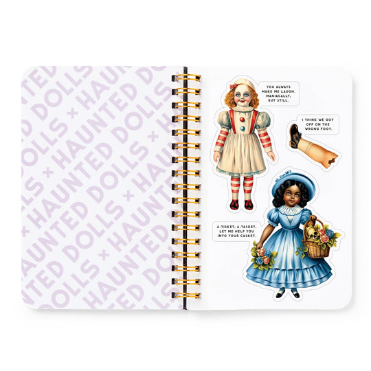 A Brass Monkey Haunted Dolls Sticker Book features a spiral-bound notebook with HAUNTED DOLLS pattern on the left and three large vintage-style Haunted Dolls stickers, each with a quirky phrase, on the right.