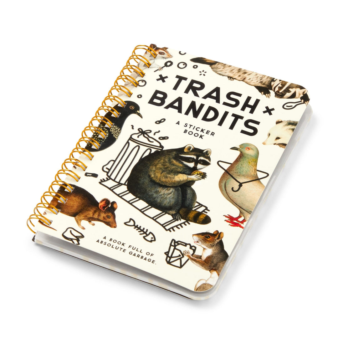 The Brass Monkey Trash Bandits Sticker Book is spiral-bound and features puffy stickers of illustrated animals (raccoon, pigeon, rat, squirrel, skunk) around a trash can. The cover reads: "A book full of absolute garbage.