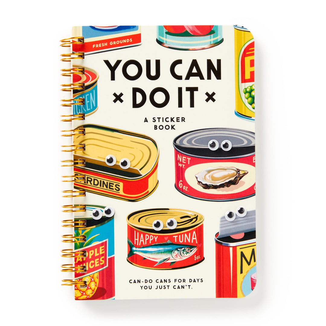 The Brass Monkey You Can Do It Googly Sticker Book is spiral-bound and features illustrated food cans with googly stickers and playful retro labels like sardines, tuna, and applesauce on the cover.