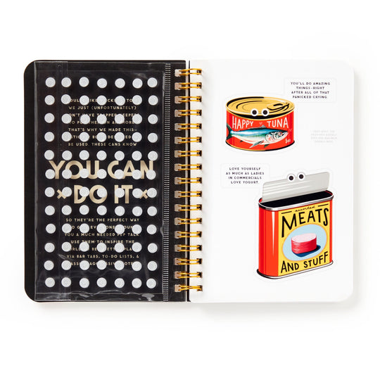 The Brass Monkey You Can Do It Googly Sticker Book is a retro-inspired spiral notebook featuring motivational text, uplifting notes, and fun tuna and meat can stickers with googly eyes.