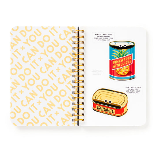 The You Can Do It Googly Sticker Book by Brass Monkey features an open spiral notebook with “YOU CAN DO IT” in bold yellow on one page and quirky googly stickers—like a pineapple can and sardine tin with eyes—plus fun motivational quotes.
