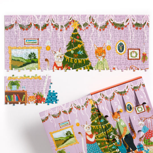 A partially completed Joanna Letz Meowy Christmas 12 Days of Puzzles 500 Piece Countdown shows playful cats, a decorated tree, garlands, and framed pictures. One large section and a few pieces are missing; the festive puzzle box is also visible.