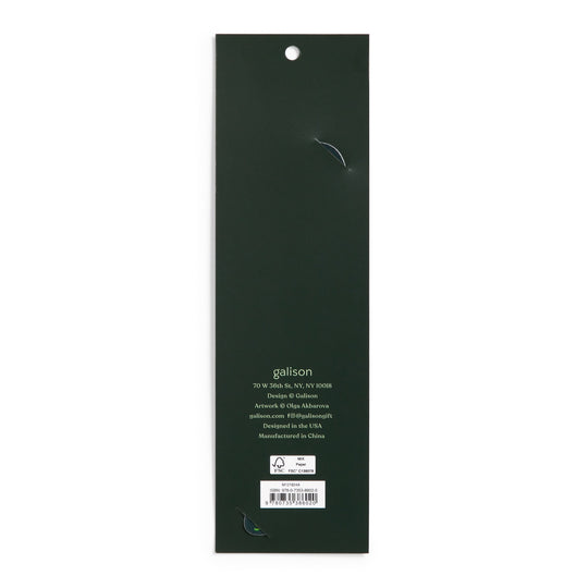 The image shows the back of a long, dark green rectangular package for the World of Mushrooms Paper Bookmark by Olga Akbarova, with a hanging hole at the top. Branding, contact info, and a barcode are near the bottom. Two small tears are visible.