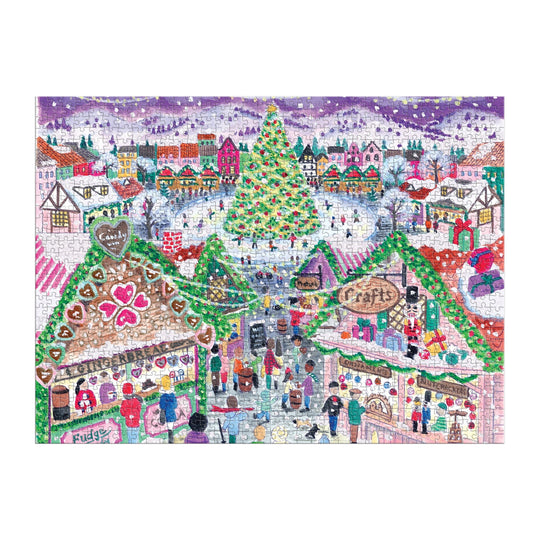The Michael Storrings Holiday Village Market 1000pc Foil Puzzle features a festive Christmas market scene with decorated stalls, shoppers, a lit tree, snowy buildings, and snow falling from a purple sky. From the Michael Storrings brand.