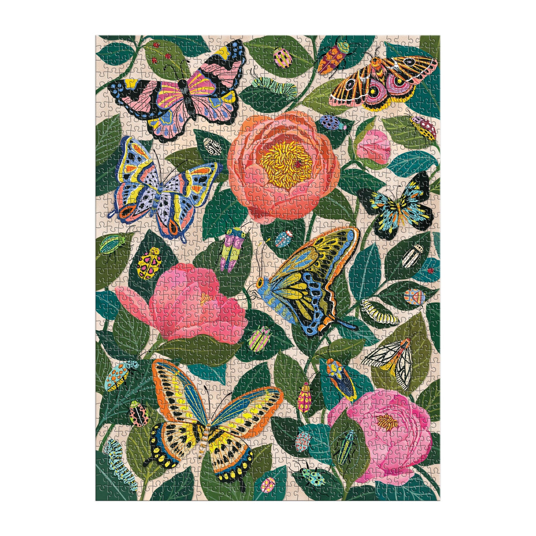 The Between the Blooms 1000 Piece Foil Puzzle by Christine De Carvalho features a vibrant botanical scene with butterflies and pink flowers among green leaves, enhanced by colorful foil accents for a lively nature-inspired challenge.