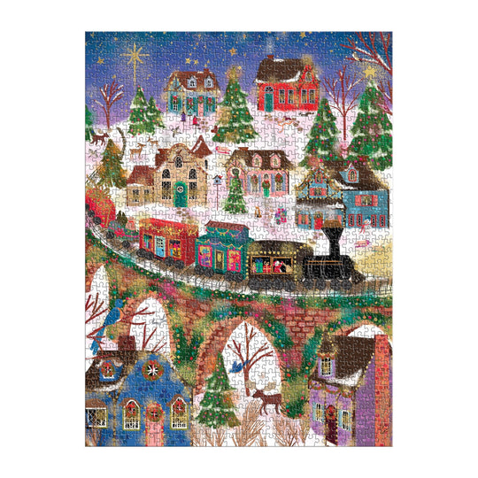 The Joy Laforme Twinkletown Express 1000 Piece Foil Puzzle features a vibrant winter village scene with snow-covered houses, a Christmas tree, and a train crossing a stone bridge beneath a starlit sky.
