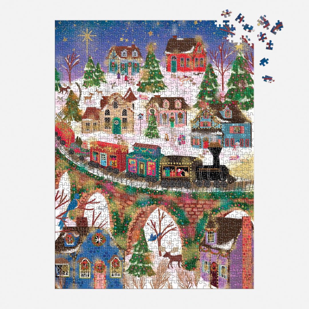 The Joy Laforme Twinkletown Express 1000 Piece Foil Puzzle by Joy Laforme features a snowy village with decorated houses, a train on a stone bridge, and a starry sky. Some pieces are missing from the upper right corner.