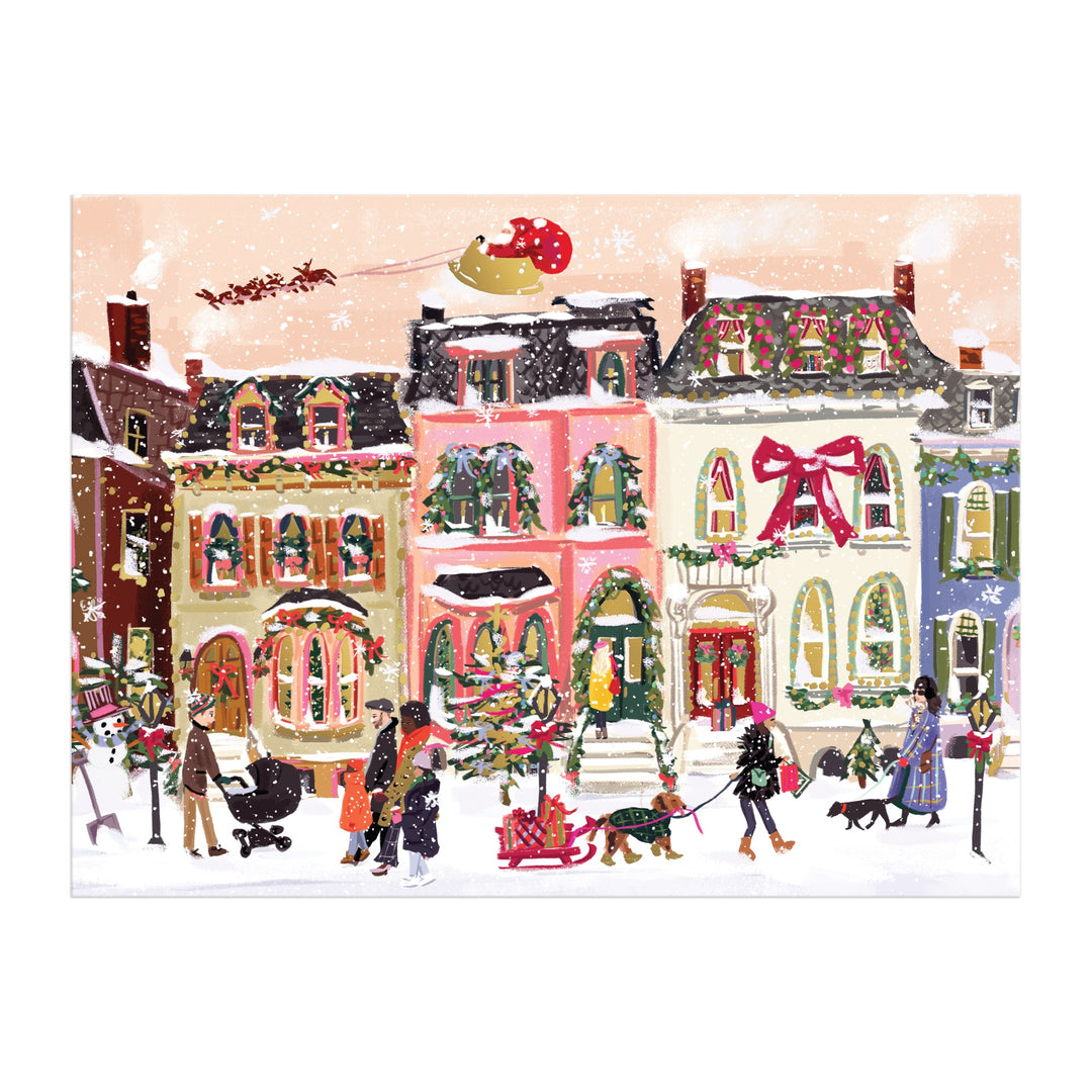 The Snowfall on Main Street 1000 Piece Foil Puzzle by Nysha Lilly features a festive winter scene with people walking dogs and decorating a Christmas tree, colorful snowy houses, and Santa’s sleigh above.