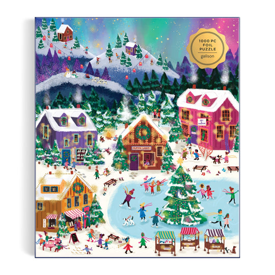 The Joy Laforme Northern Lights 1000 Piece Foil Puzzle by Joy Laforme features a vibrant winter village with people skating, skiing, and strolling past snowy houses and festive stalls beneath a starry sky illuminated by northern lights.
